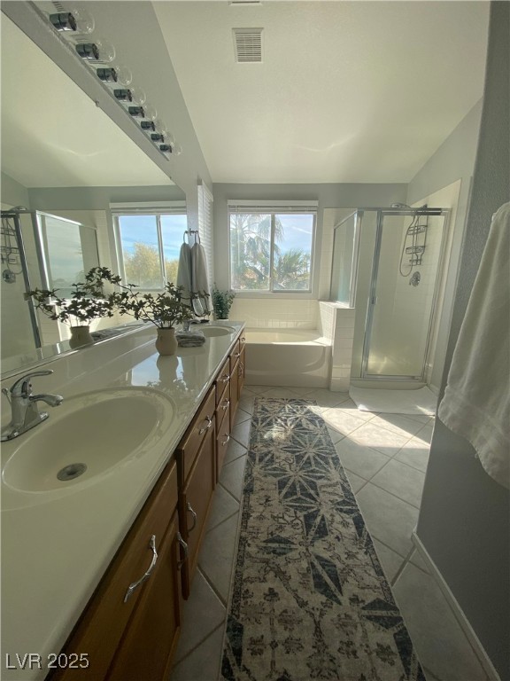 10637 Amblewood Avenue Las Vegas, NV 89144 - Photo 9 of 32 Full bathroom with a shower stall, a garden tub, double vanity, and light tile patterned flooring