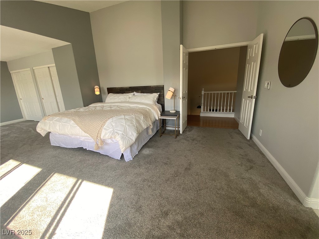 10637 Amblewood Avenue Las Vegas, NV 89144 - Photo 10 of 32 Carpeted bedroom featuring baseboards and two closets