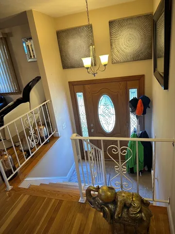 a view of entryway and hall with wooden floor
