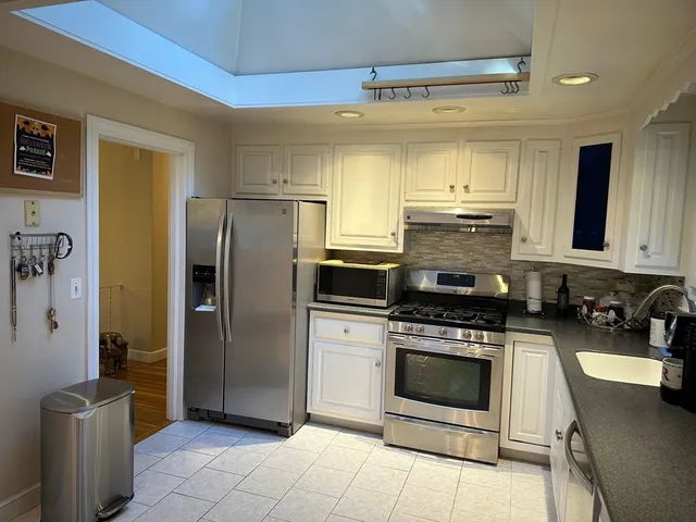 a living room with furniture chandelier and rug