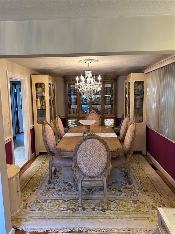 223 Robert Road Dedham, MA 02026 - Photo 6 of 18 a living room with furniture chandelier and rug