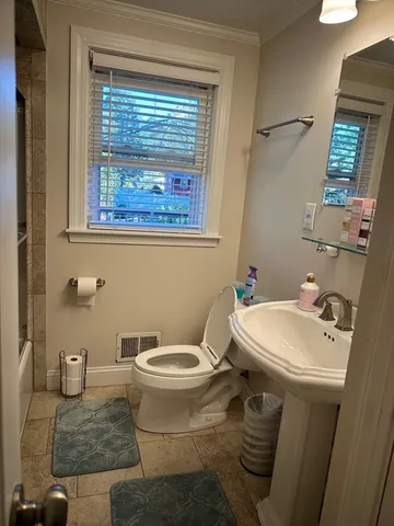 a bathroom with a toilet and a shower