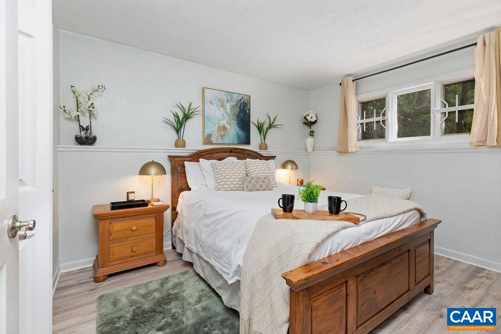 490 3 Ridges Roseland, VA 22967 - Photo 8 of 27 a bedroom with a bed and wooden floor