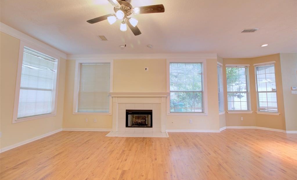 1226 Rabbs Crossing Sugar Land, TX 77479 - Photo 12 of 50 a view of an empty room with a fireplace and a window