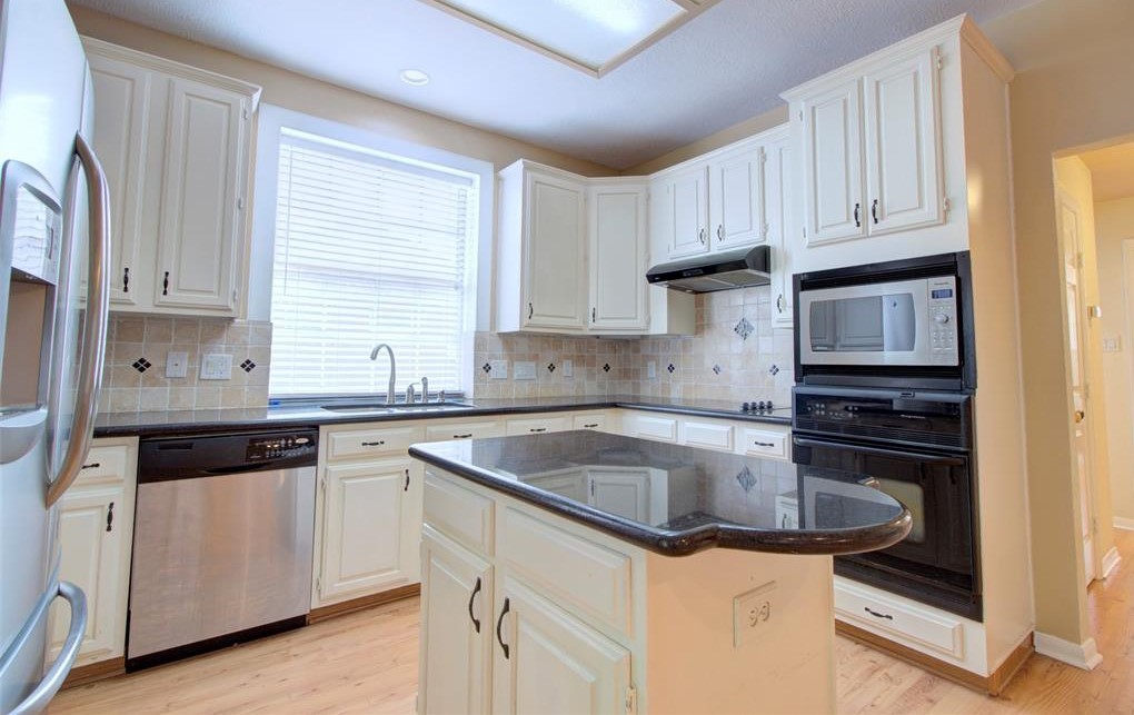 1226 Rabbs Crossing Sugar Land, TX 77479 - Photo 17 of 50 a kitchen with granite countertop a sink stove and cabinets
