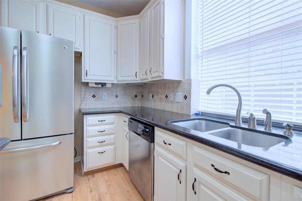 1226 Rabbs Crossing Sugar Land, TX 77479 - Photo 20 of 50 a kitchen with granite countertop a refrigerator sink and cabinets