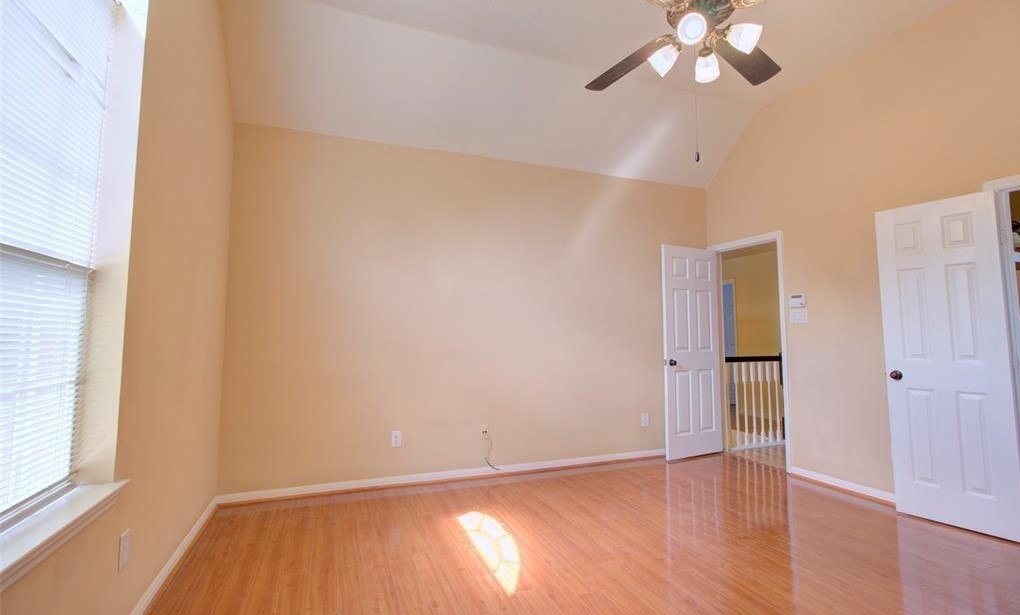 1226 Rabbs Crossing Sugar Land, TX 77479 - Photo 35 of 50 an empty room with wooden floor fan and windows