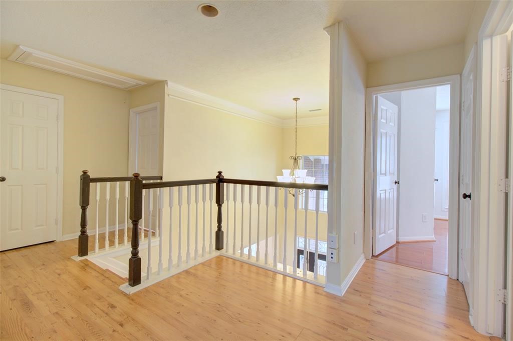 1226 Rabbs Crossing Sugar Land, TX 77479 - Photo 44 of 50 a view of a hallway with wooden floor and staircase