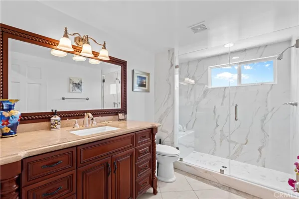 an aerial view of residential houses with outdoor space and trees