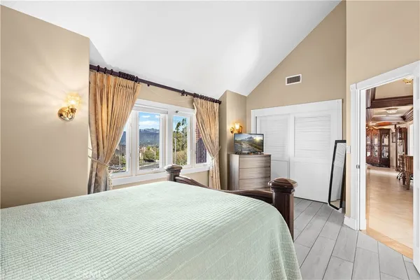 a room with furniture a bookshelf and a window