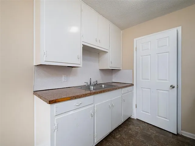a kitchen with stainless steel appliances granite countertop white cabinets sink and dishwasher