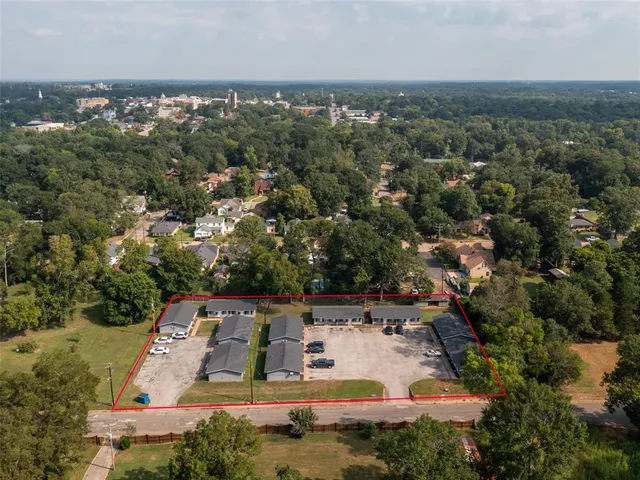 an aerial view of house with yard and mountain view in back