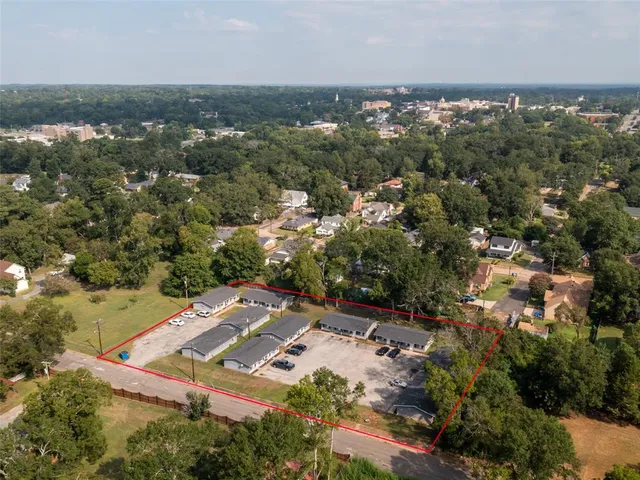an aerial view of a house with a yard
