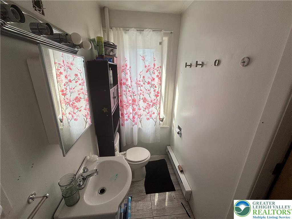 3404 North Ruch Street Whitehall, PA 18052 - Photo 25 of 36 A well-lit powder room offers practicality and a compact design, perfect for daily routines.