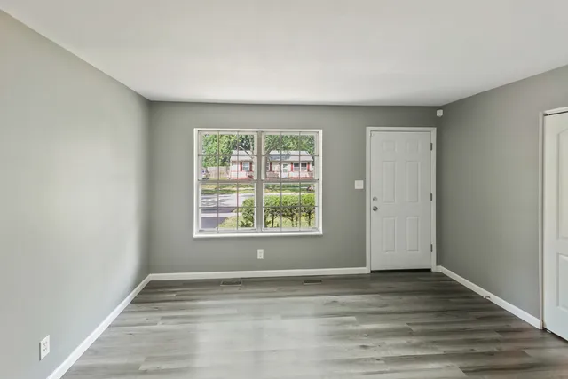 a view of room with window and hardwood floor