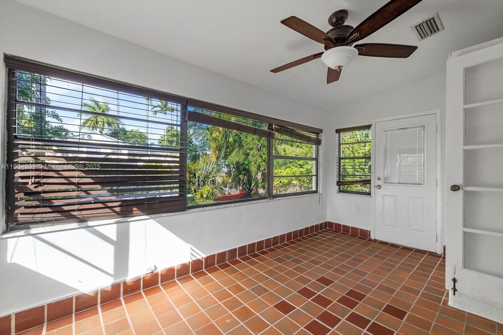 8826 Emerson Avenue Surfside, FL 33154 - Photo 17 of 25 a view of empty room with wooden floor and fan