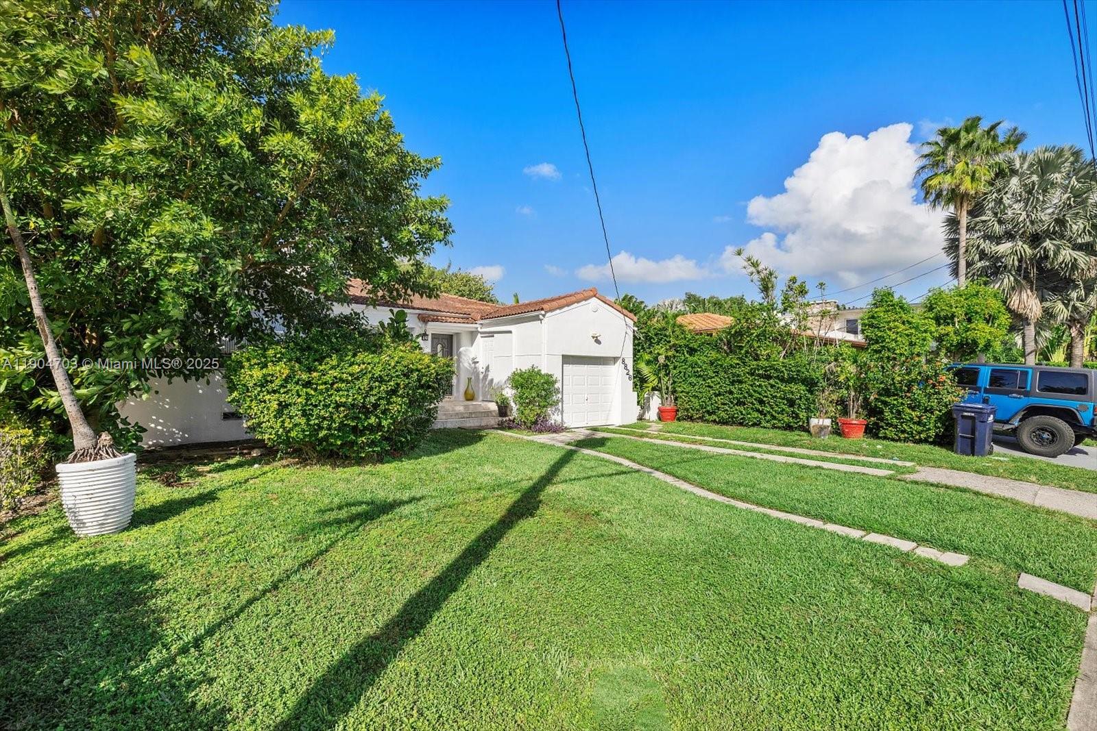 8826 Emerson Avenue Surfside, FL 33154 - Photo 2 of 25 a view of a house with a backyard