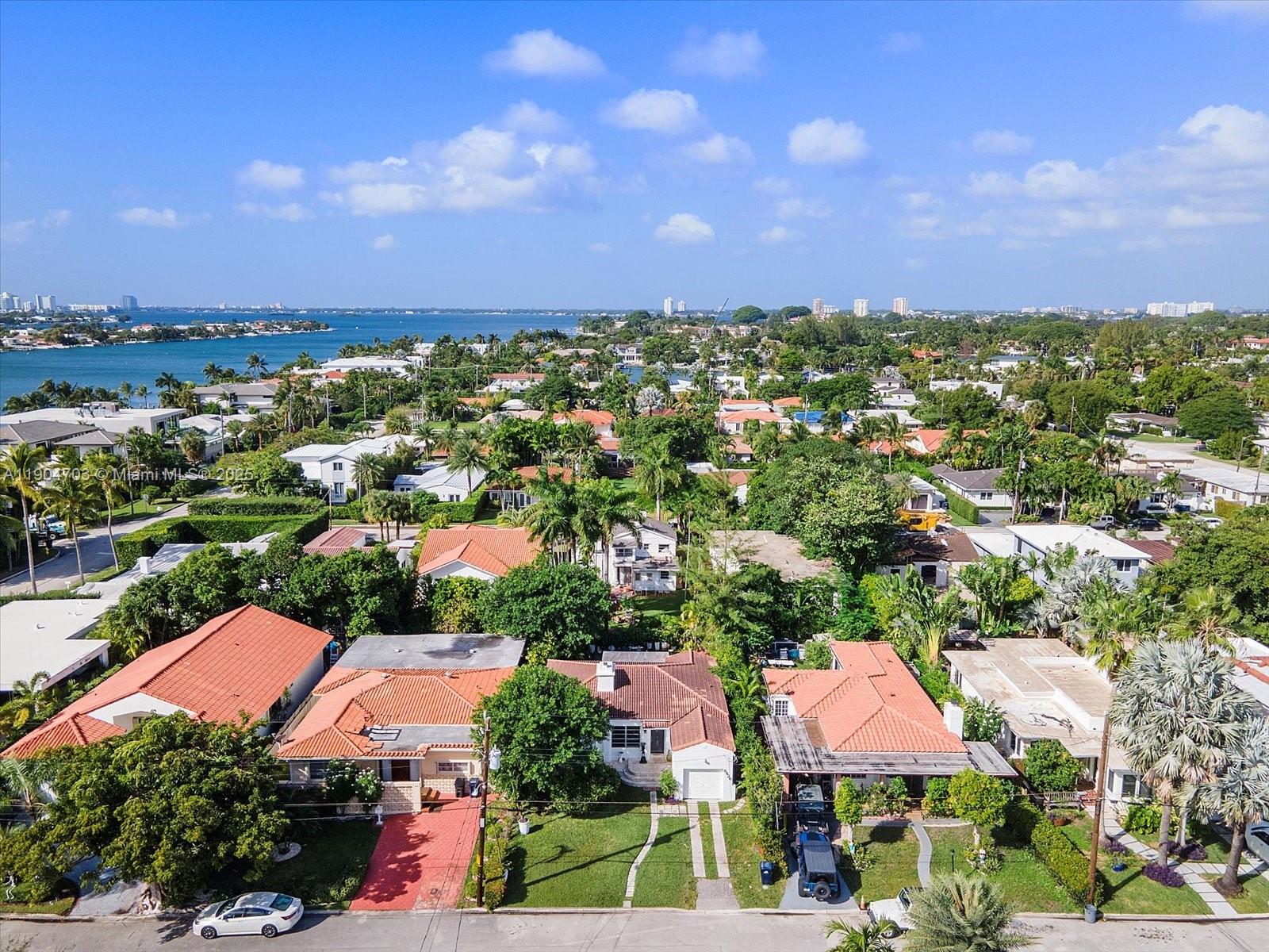 8826 Emerson Avenue Surfside, FL 33154 - Photo 21 of 25 an aerial view of a houses with a city street view and lake view