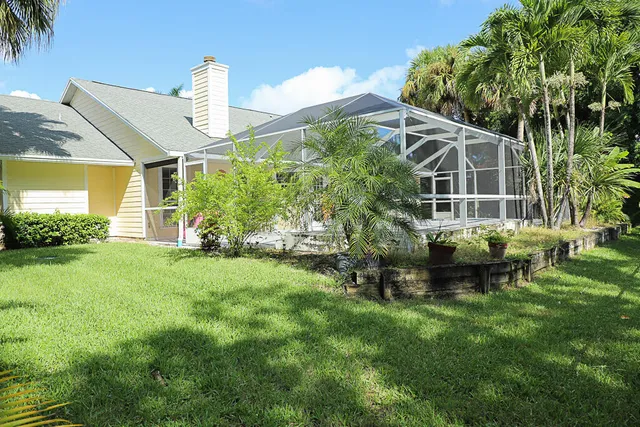 a backyard of a house with table and chairs