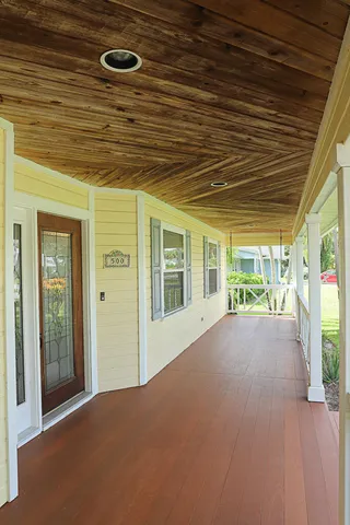 a view of a porch with wooden floor