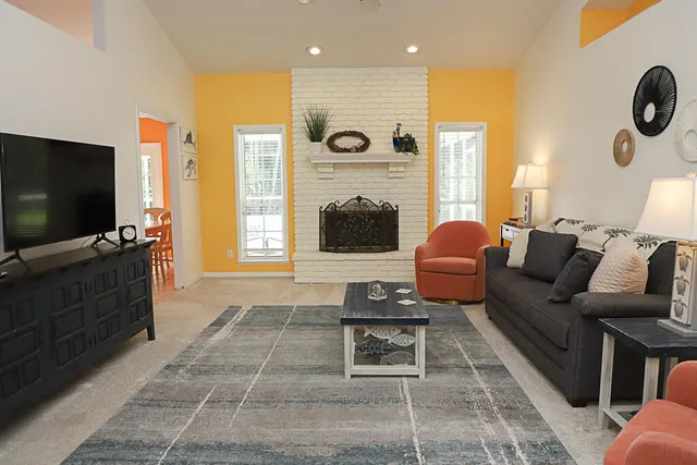a living room with furniture and a flat screen tv