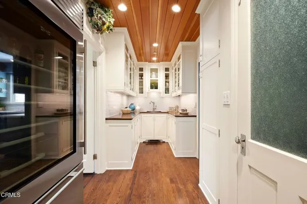a view of kitchen with refrigerator and window