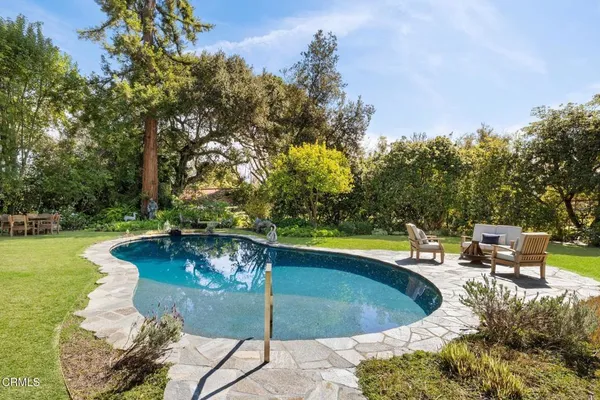 a view of a swimming pool with an outdoor seating and a yard