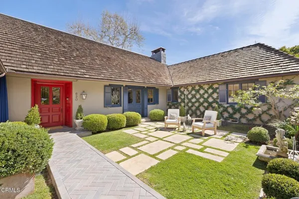 a view of a patio with couches table and chairs and potted plants
