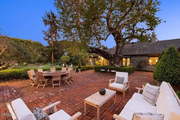 a backyard of a house with outdoor seating