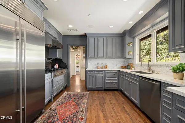 a kitchen with a sink stove and refrigerator
