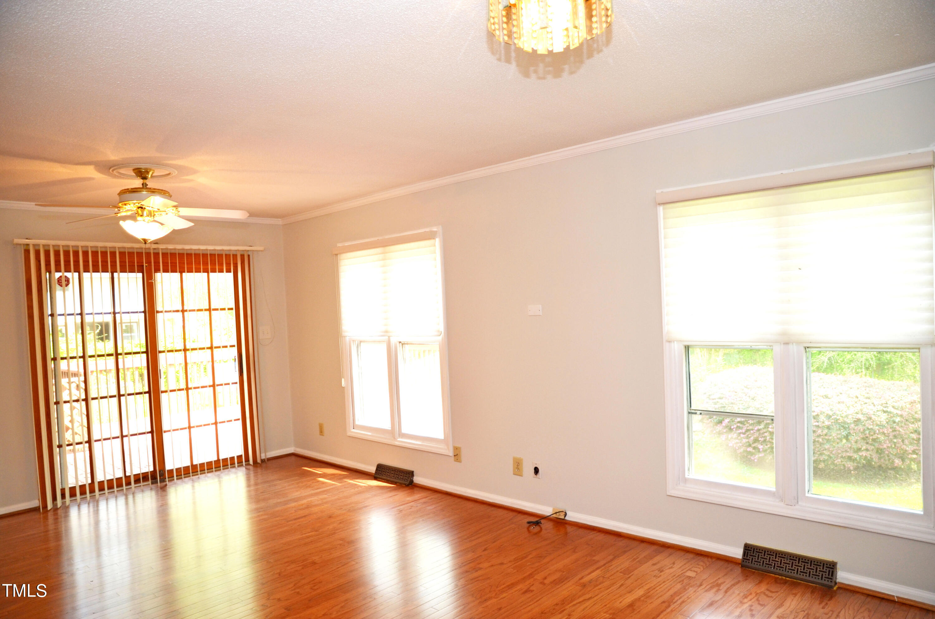 5708 Old Forge Circle Raleigh, NC 27609 - Photo 11 of 31 a view of an empty room with wooden floor and a window