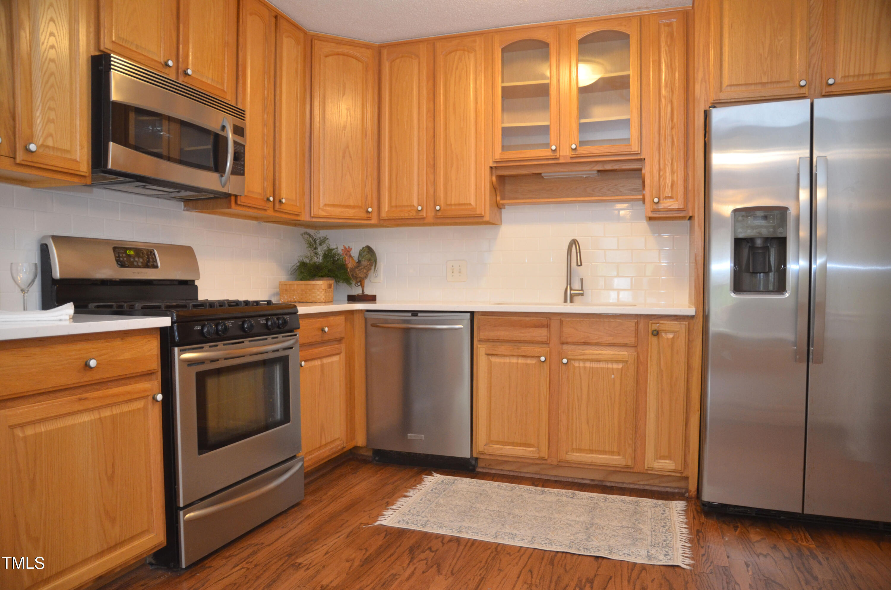 5708 Old Forge Circle Raleigh, NC 27609 - Photo 2 of 31 a kitchen with stainless steel appliances granite countertop a stove a sink and a microwave