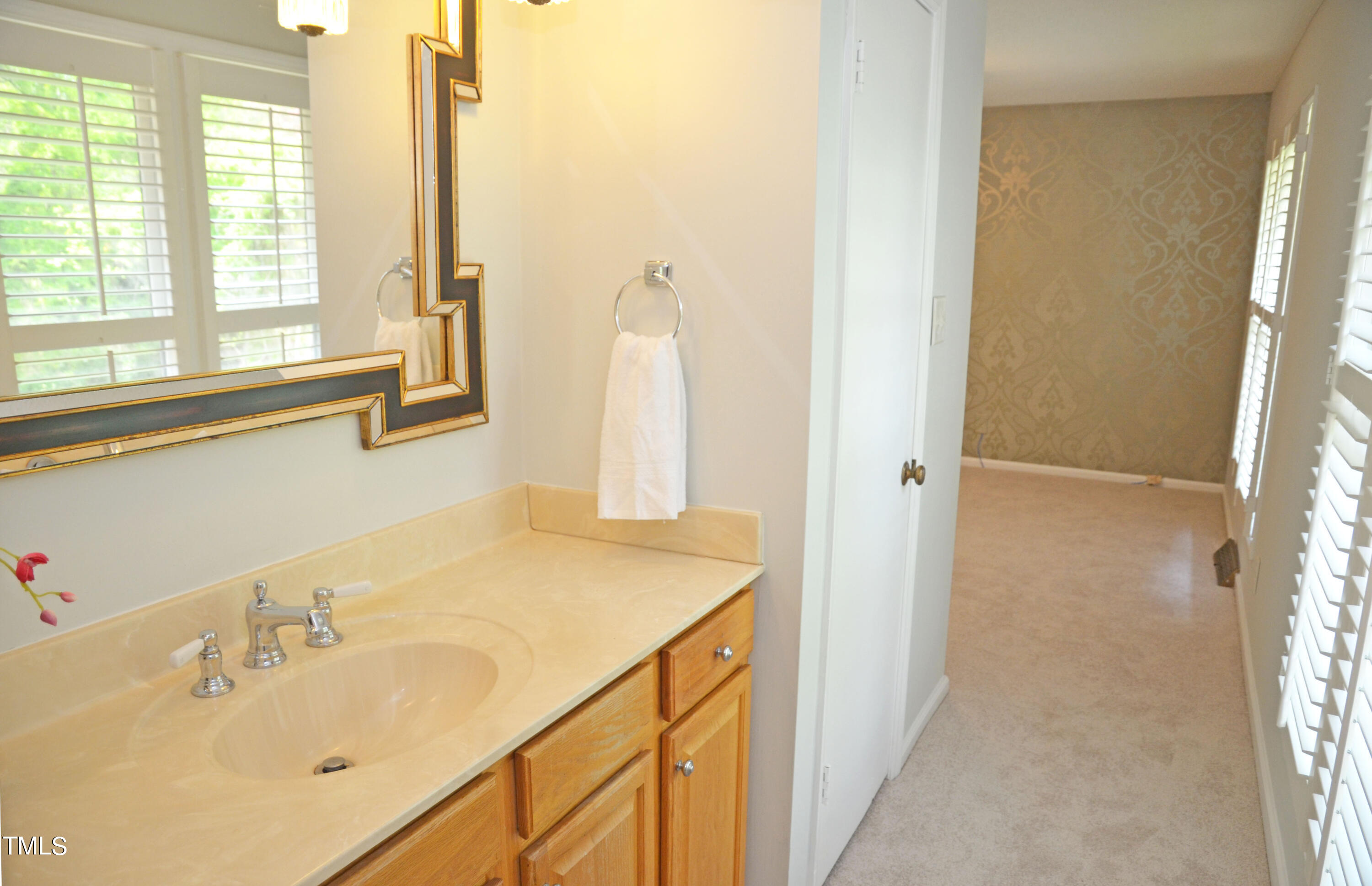 5708 Old Forge Circle Raleigh, NC 27609 - Photo 21 of 31 a bathroom with a sink and a mirror