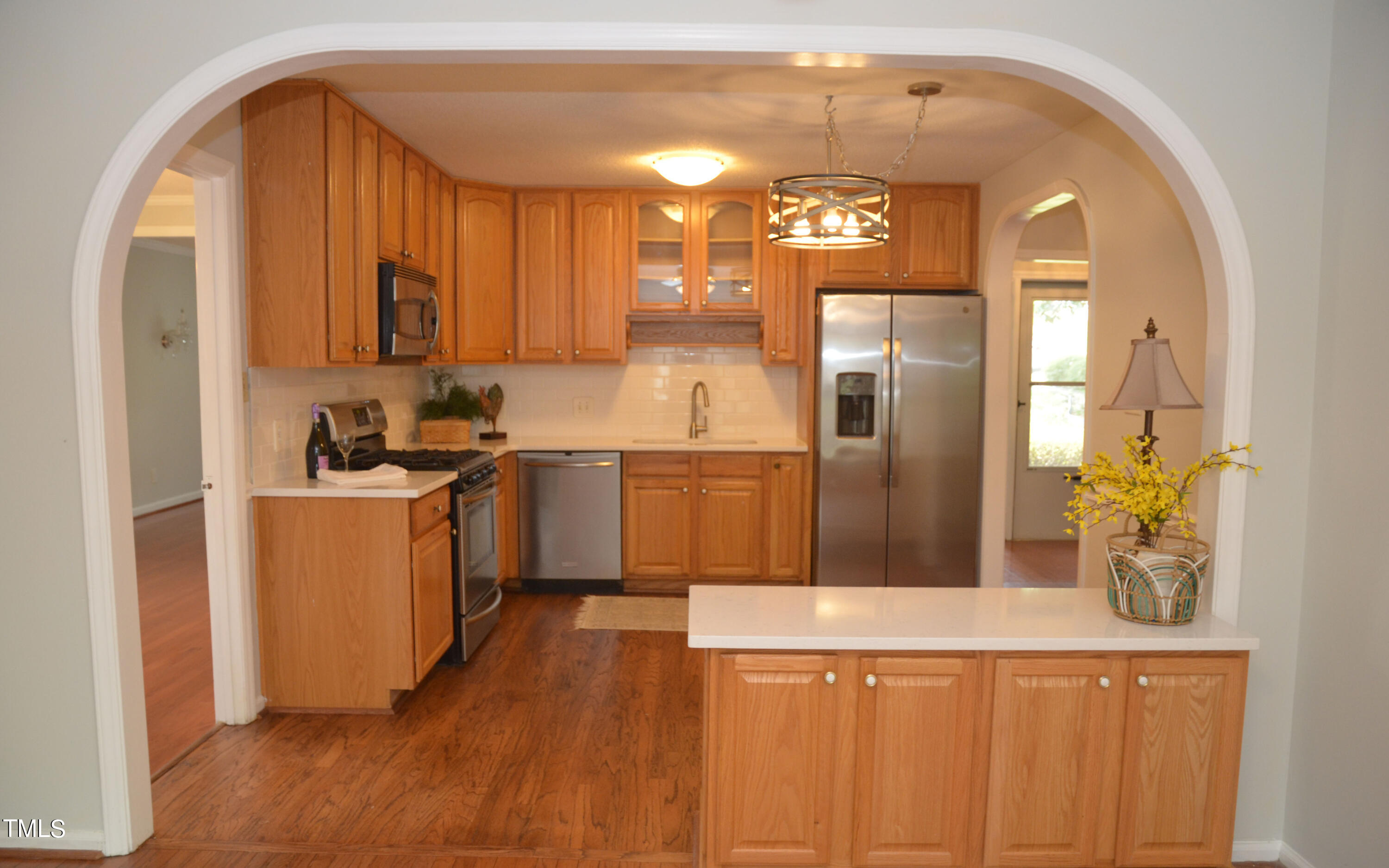 5708 Old Forge Circle Raleigh, NC 27609 - Photo 5 of 31 a kitchen with a refrigerator a sink and dishwasher with wooden floor