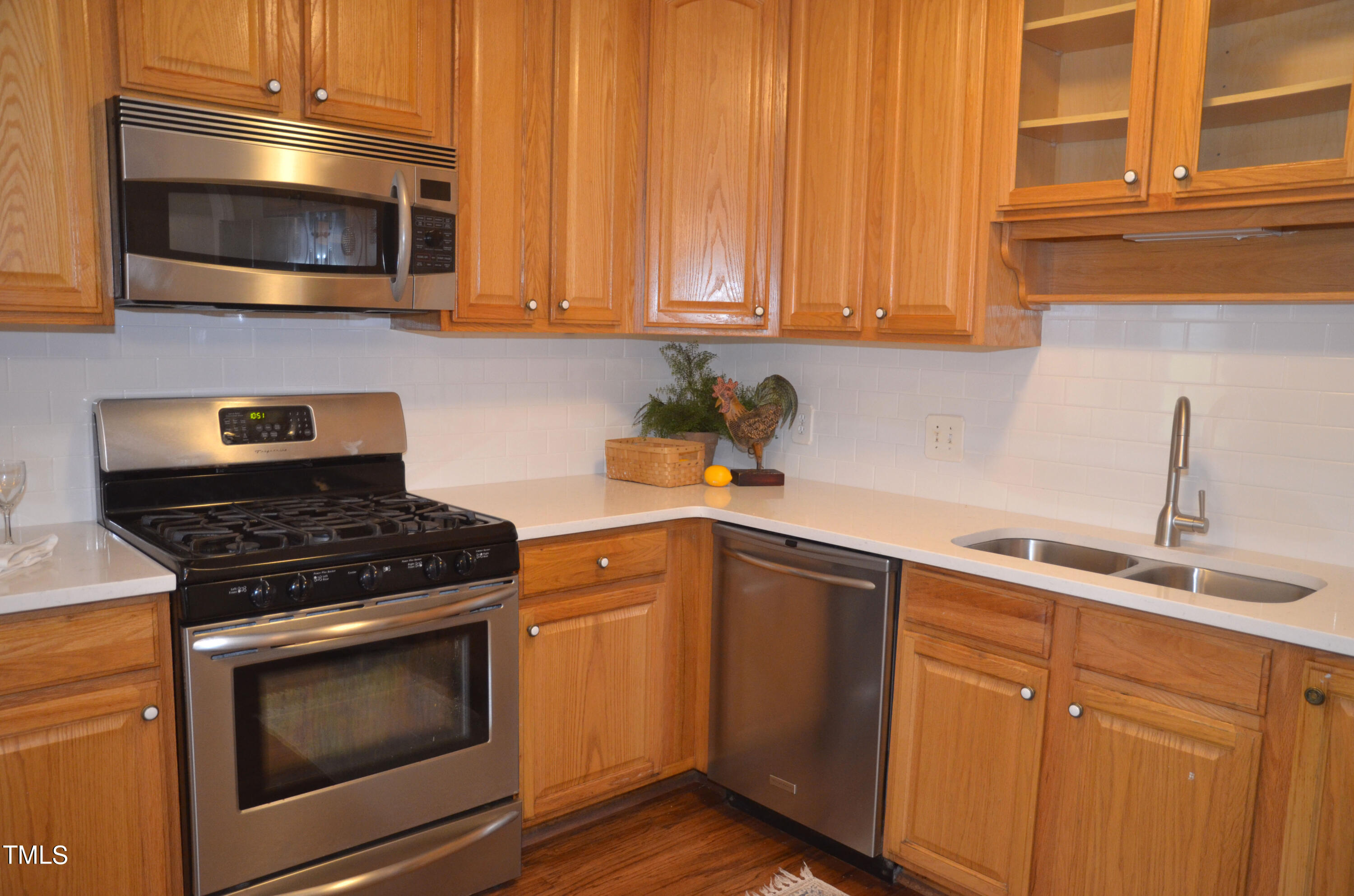 5708 Old Forge Circle Raleigh, NC 27609 - Photo 6 of 31 a kitchen with granite countertop white cabinets and stainless steel appliances