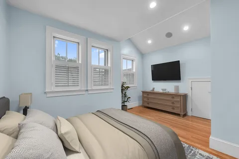 a bedroom with a bed and a flat screen tv