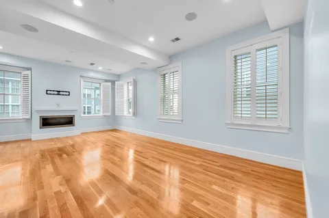 a view of empty room with fireplace and window