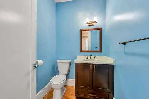 a bathroom with a toilet sink and mirror