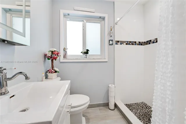 a bathroom with a sink toilet and shower