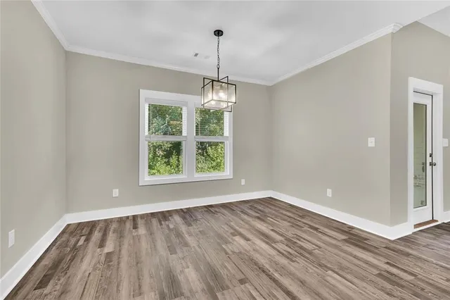 a view of room with window and hardwood floor