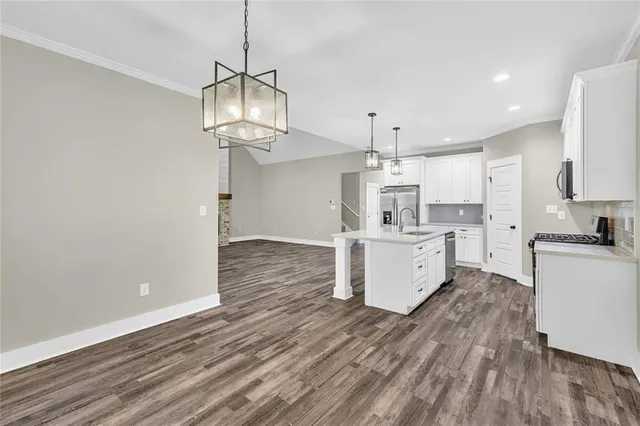 a kitchen with a refrigerator and white cabinets