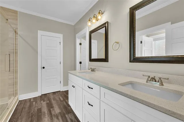 a bathroom with a shower sink and mirror