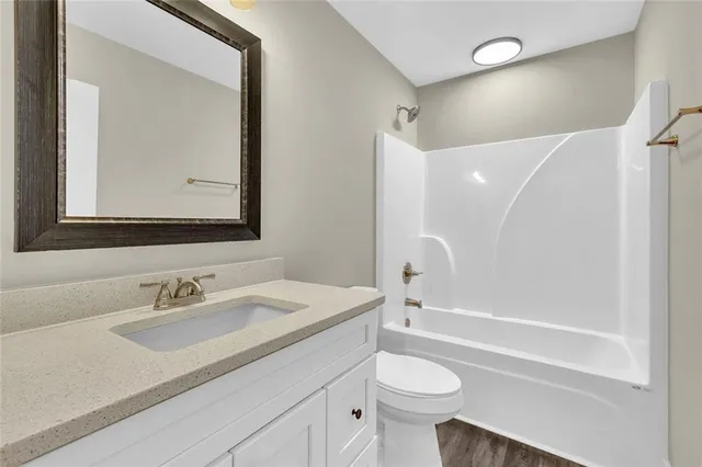 an empty room with windows and fan chandelier fan