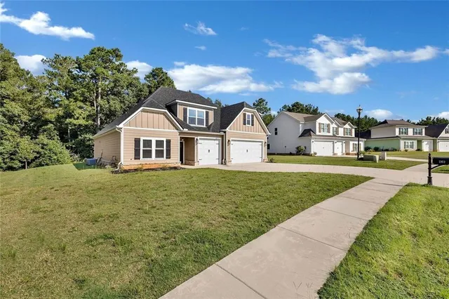 an aerial view of a house with a yard