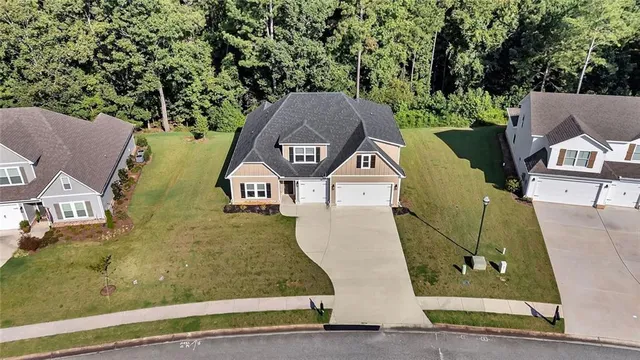 an aerial view of a house with a yard and trees