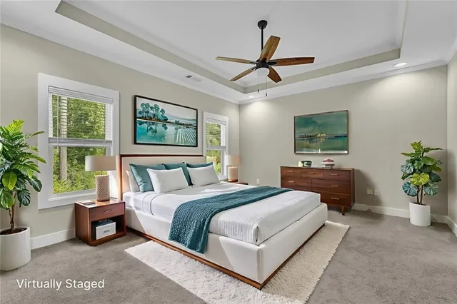 a spacious bedroom with a bed and a potted plant