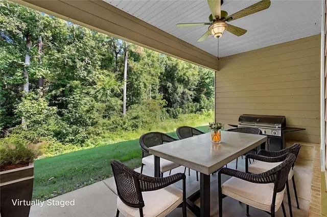 a view of a porch with furniture and a yard