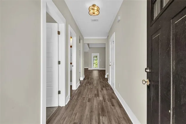 a view of a hallway with wooden floor