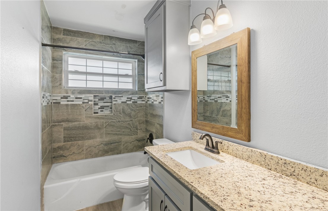 1333 Prince Drive Corpus Christi, TX 78412 - Photo 11 of 20 a bathroom with a granite countertop sink toilet and shower
