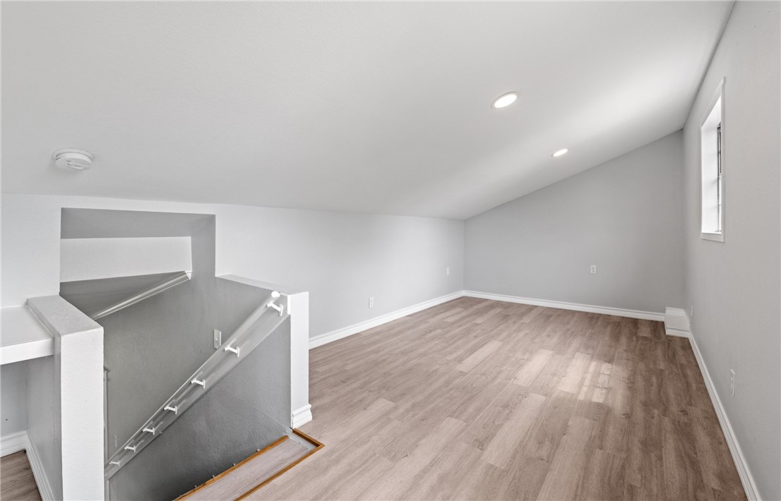 1333 Prince Drive Corpus Christi, TX 78412 - Photo 16 of 20 a view of an empty room with wooden floor and a window